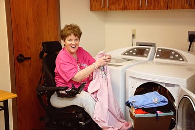 A resident doing laundry in a common area