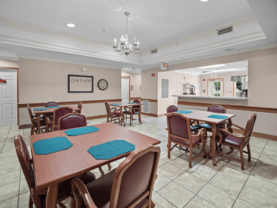 Dining area with tables and chairs set for residents