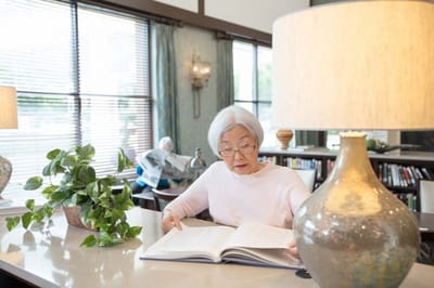 Resident reading in a cozy common area