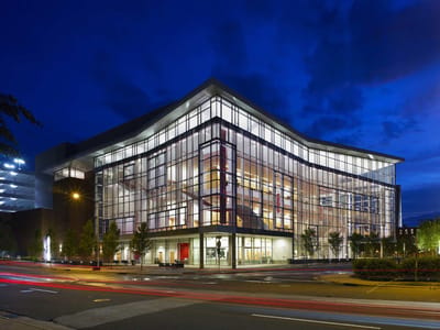 Modern building exterior at night with glass facade