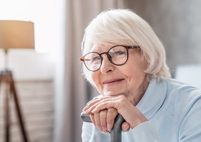 Smiling elderly woman in a cozy interior setting