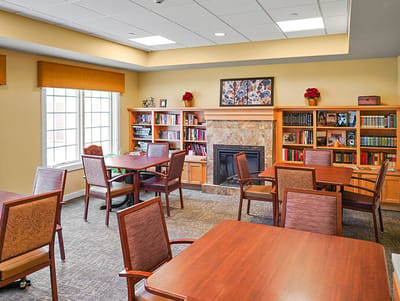 Cozy common area with bookshelves and fireplace