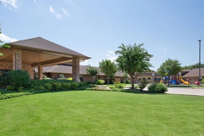 Exterior view of the facility with landscaped grounds