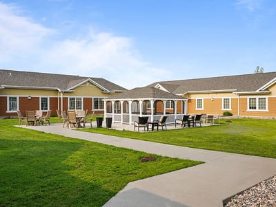 Outdoor gazebo area with seating in a senior living facility