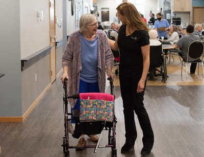 Staff assisting a resident in the common area