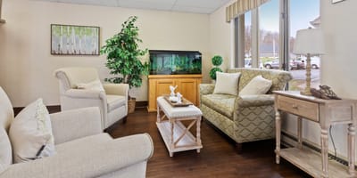 Bright common area with comfortable seating and aquarium