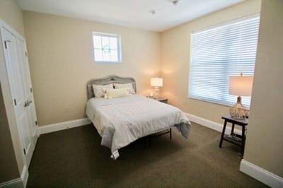 Bright, furnished private resident room with bed and window