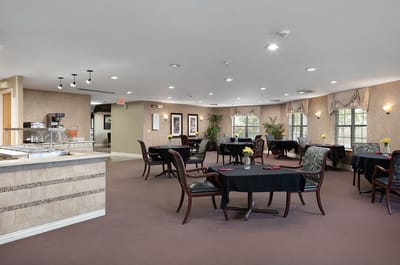 Dining area with tables and chairs arranged for residents