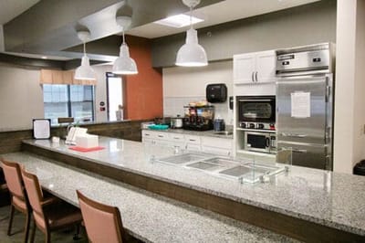 Modern kitchen area with granite countertops and seating