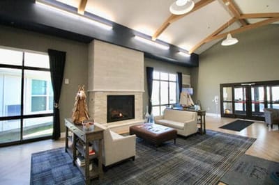 A cozy common area with seating and fireplace