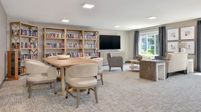 A bright common area with bookshelves and seating