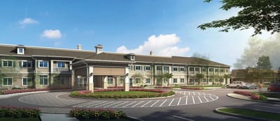 Front entrance of a nursing home facility with landscaping