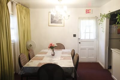 A dining area with a table and chairs