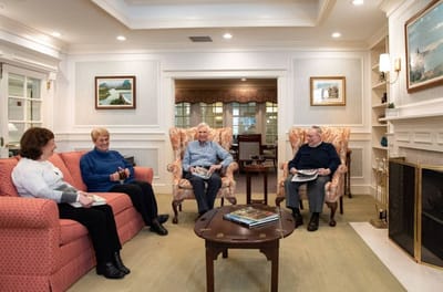 Residents enjoying conversation in a cozy common area
