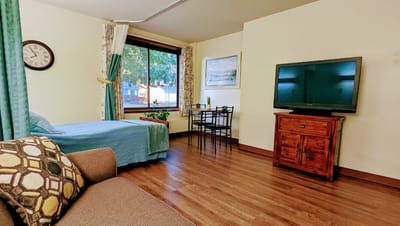 A cozy resident room with a bed and seating area