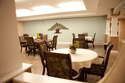 Bright dining area with tables and a mural
