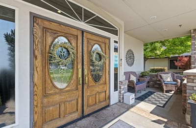 Welcoming entrance with double doors and seating area