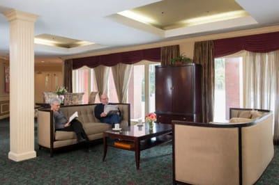 Residents enjoying a quiet moment in the lounge area