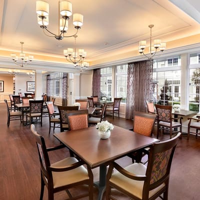 Bright common area with dining tables and chairs