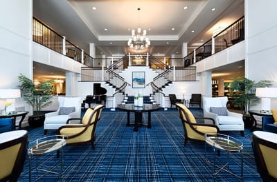 Bright interior lounge with elegant staircase and seating