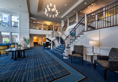 Bright and spacious lobby with seating and staircase