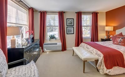 Cozy private resident room with large windows and seating area