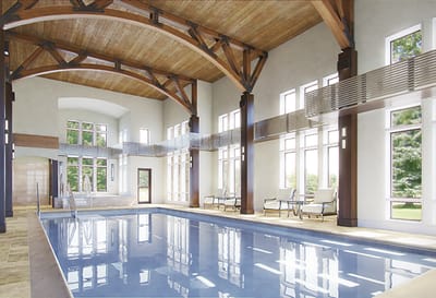 Indoor swimming pool with large windows and seating