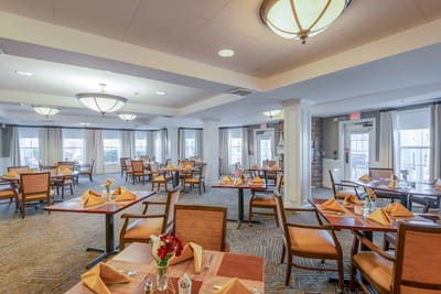 Bright dining room with tables set for a meal
