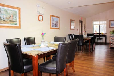Dining area with tables and chairs in a warm interior setting