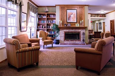 Cozy common area with seating and bookshelf