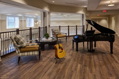 Common area with piano and seating