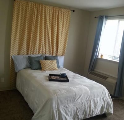 Cozy private resident room with bed and decor