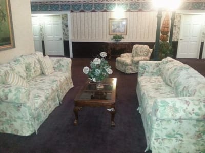 Cozy interior common area with floral sofas and a coffee table