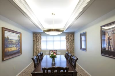 Dining room with a large wooden table and floral decor