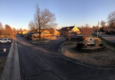 Exterior view of Carmel Home facility during sunset