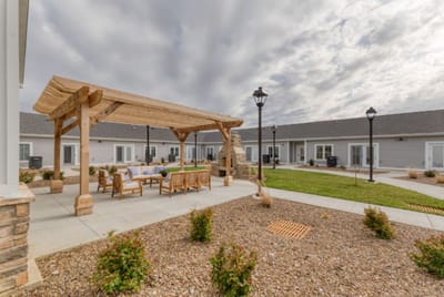 Outdoor seating area with pergola and landscaping