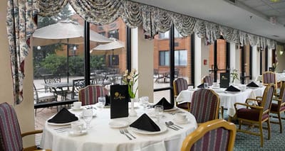 Dining room setup with outdoor views and flowers