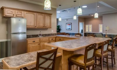 Bright common area kitchen with seating and modern decor