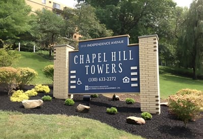 Chapel Hill Towers, independent living in Akron, OH — Sign for Chapel Hill Towers with landscaping and trees