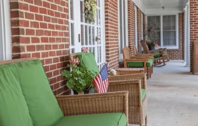 A welcoming outdoor seating area with green chairs