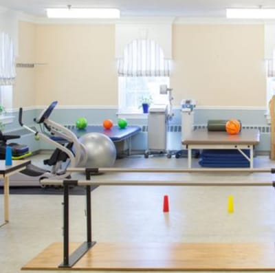 Rehabilitation gym with exercise equipment and colorful balls