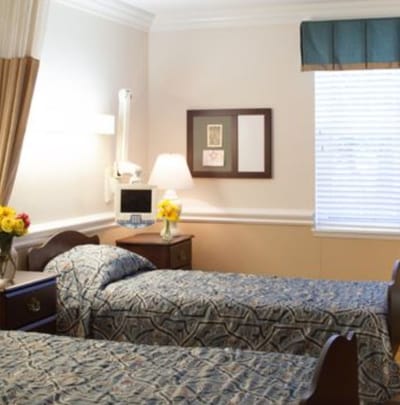 Cozy shared resident room with twin beds and decor