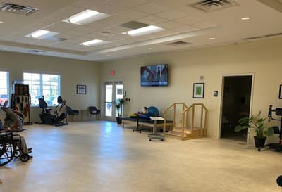 Well-lit activity room with exercise equipment