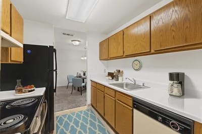 Bright kitchen area with wooden cabinets and sink