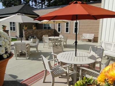 Outdoor seating area with tables and umbrellas