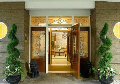 Front entrance of a senior living facility with elegant doors