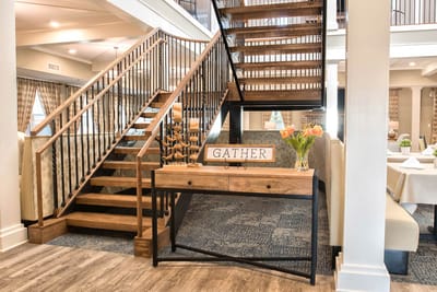 Interior view of a welcoming common area with a staircase