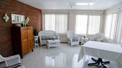 Bright and airy common area with wicker furniture