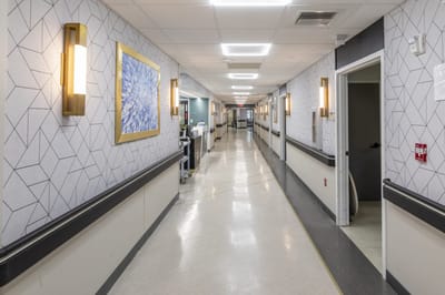 A well-lit hallway in a senior living facility