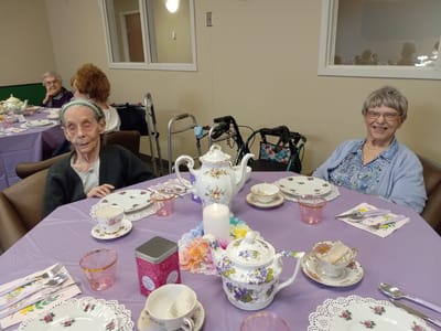 Residents enjoying tea time in a common area